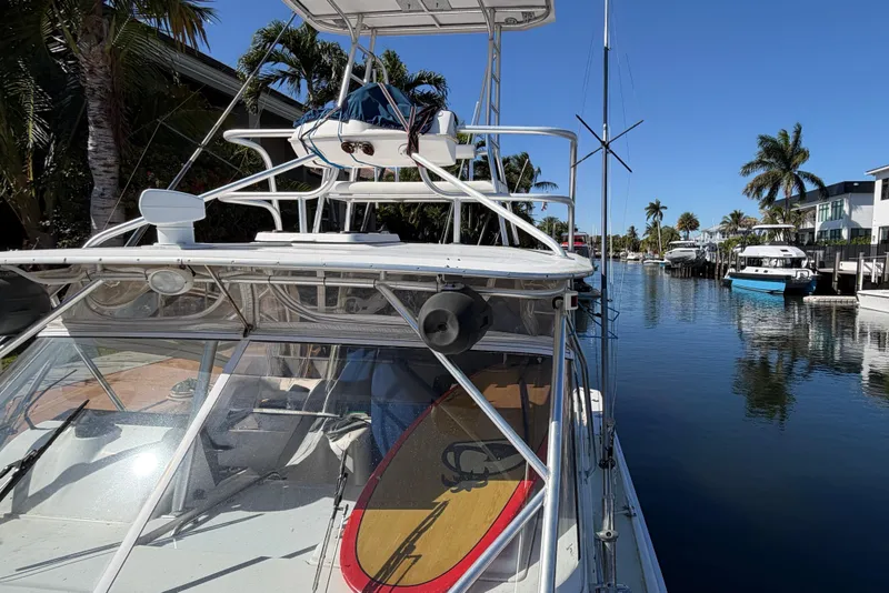 Slide: The Image of 2007 Luhrs 28 Open boat docked in a scenic canal with palm trees. - 29