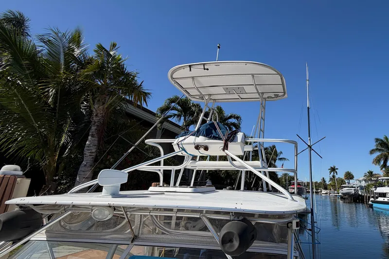 Slide: The Image of 2007 Luhrs 28 Open boat docked near palm trees under clear blue sky. - 30