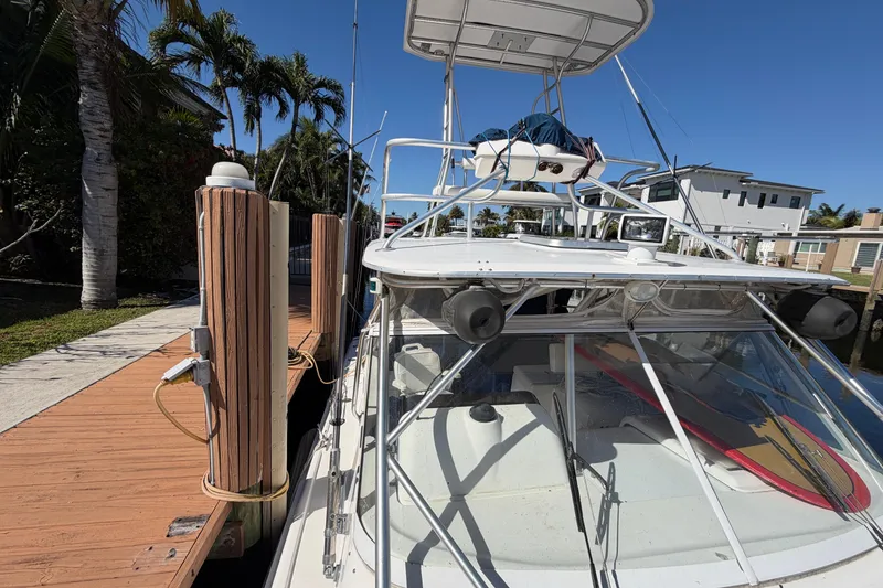 Slide: The Image of 2007 Luhrs 28 Open boat docked, featuring a spacious deck and clear blue sky. - 31