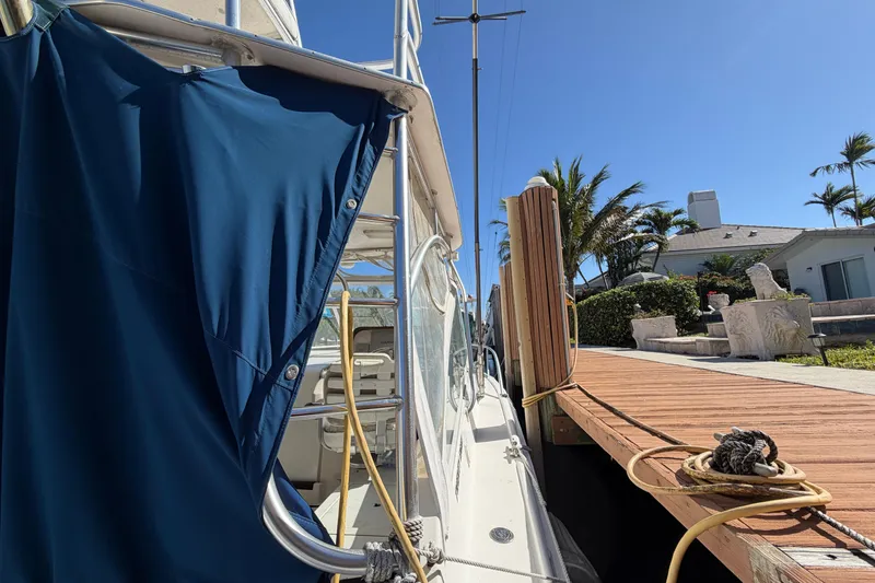 Slide: The Image of 2007 Luhrs 28 Open boat docked beside a wooden pier under clear blue skies. - 32