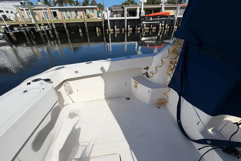 Slide: The Image of 2007 Luhrs 28 Open boat deck with dockside view and blue canopy. - 37