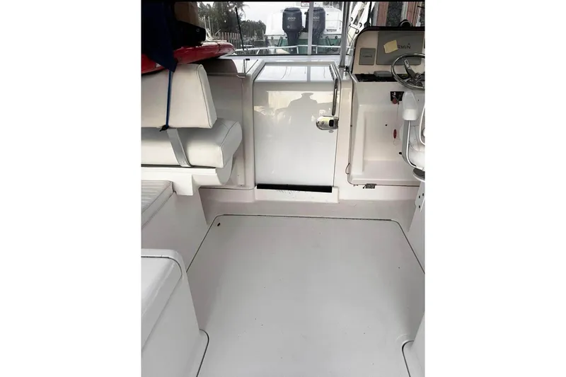 Slide: The Image of 2007 Lurhs Offshore Sport Fish boat docked by waterfront homes. - 4