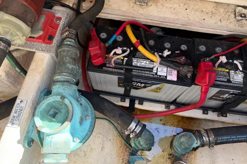 Slide: The Image of Engine compartment of a 2007 Luhrs 28 Open with batteries and water strainer. - 43