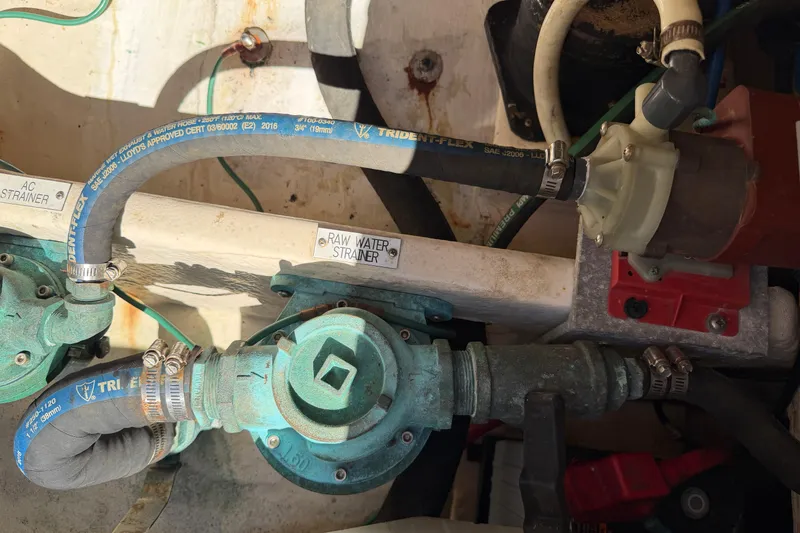 Slide: The Image of Engine compartment of a 2007 Luhrs 28 Open boat showing raw water strainer and hoses. - 45