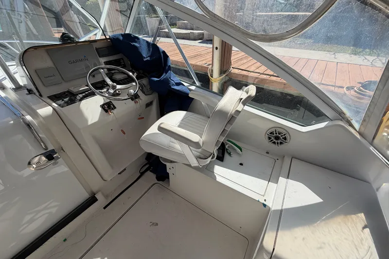 Slide: The Image of 2007 Luhrs 28 Open boat cockpit with steering wheel and seating area. - 47