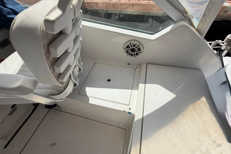 Slide: The Image of 2007 Luhrs 28 Open boat interior with white seating and speaker detail. - 49