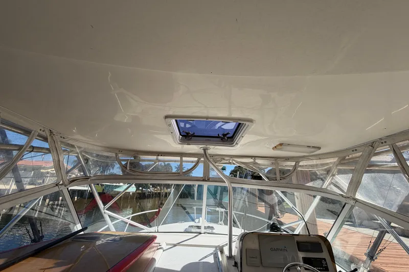 Slide: The Image of 2007 Luhrs 28 Open boat interior with clear canopy and Garmin navigation system. - 54