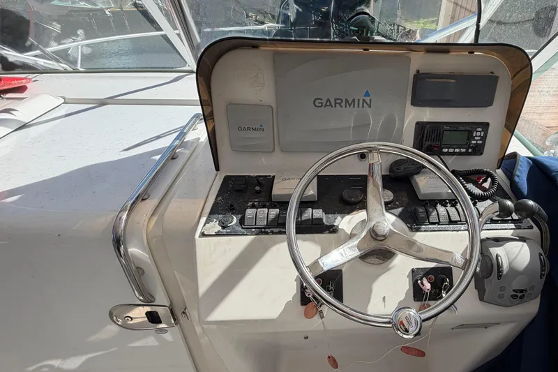 Slide: The Image of 2007 Luhrs 28 Open boat helm with Garmin navigation system and steering wheel. - 56