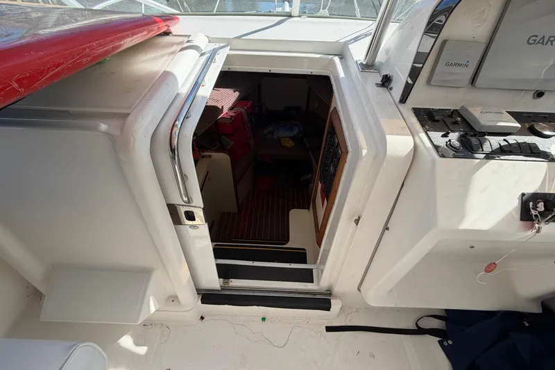 Slide: The Image of 2007 Luhrs 28 Open boat interior with cabin entrance and navigation equipment. - 62