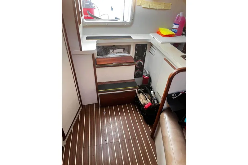 Slide: The Image of 2007 Luhrs Offshore Sport Fish boat interior with wooden flooring and storage compartments. - 63