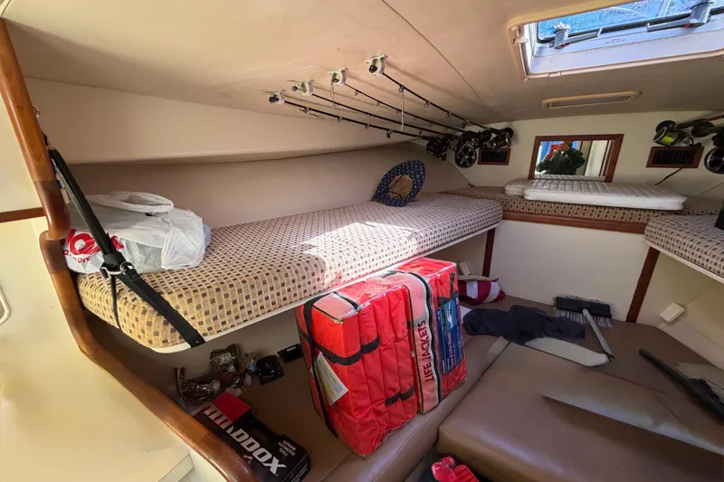 Slide: The Image of Interior cabin of 2007 Luhrs 28 Open boat with fishing rods and life jackets. - 67