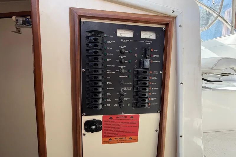 Slide: The Image of Electrical control panel on a 2007 Luhrs 28 Open boat, featuring various switches and gauges. - 70