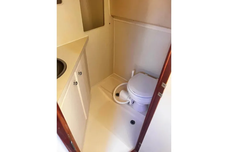 Slide: The Image of 2007 Luhrs Offshore Sport Fish boat bathroom with toilet and sink. - 71