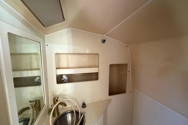 Slide: The Image of 2007 Luhrs 28 Open boat interior with sink and storage shelves. - 72