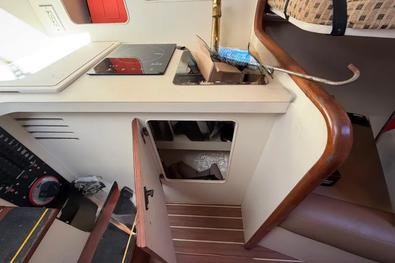 Slide: The Image of 2007 Luhrs 28 Open boat interior with kitchenette and storage. - 76