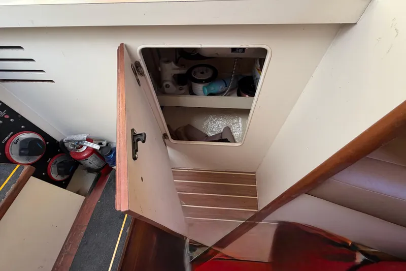 Slide: The Image of 2007 Luhrs 28 Open boat interior storage compartment with open door and visible fire extinguisher. - 77