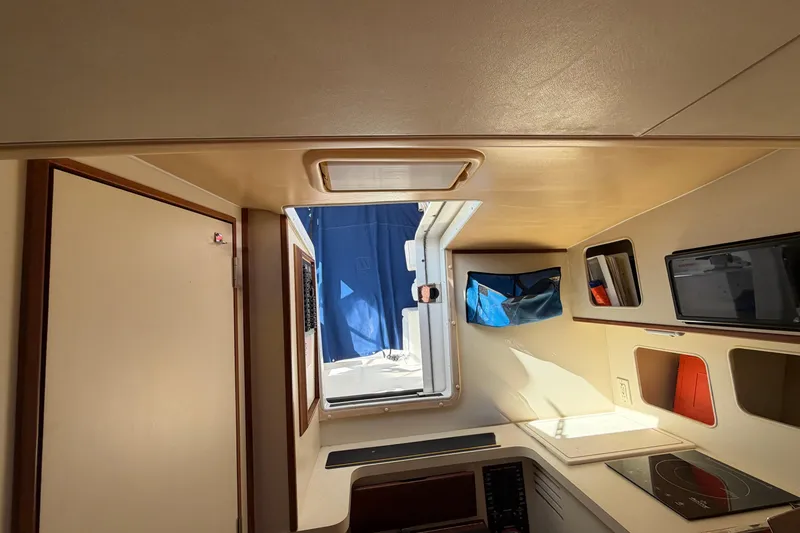 Slide: The Image of Interior of 2007 Luhrs 28 Open boat, featuring compact kitchen and storage spaces. - 79