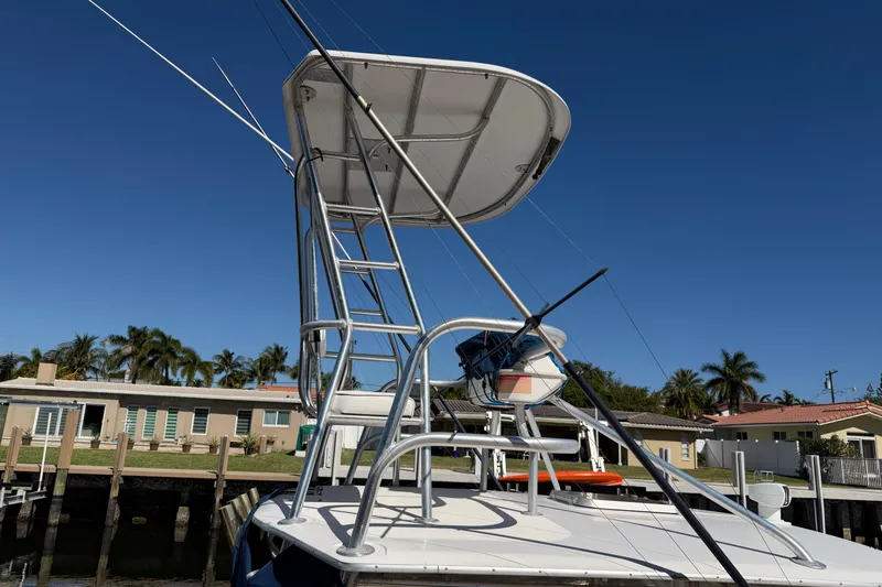 Slide: The Image of 2007 Luhrs 28 Open boat with tower, docked near palm trees and houses. - 8