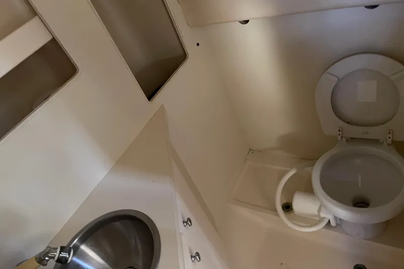 Slide: The Image of 2007 Luhrs 28 Open boat bathroom with toilet and sink. - 83