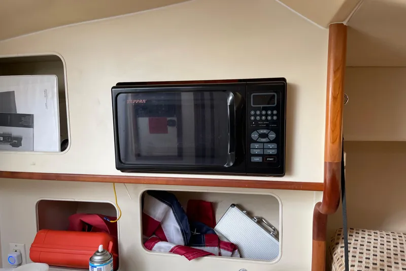 Slide: The Image of 2007 Luhrs 28 Open interior with microwave and storage compartments. - 84