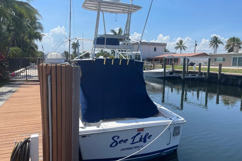 Slide: The Image of 2007 Luhrs 28 Open boat docked, named "See Life," in a sunny marina setting. - 91