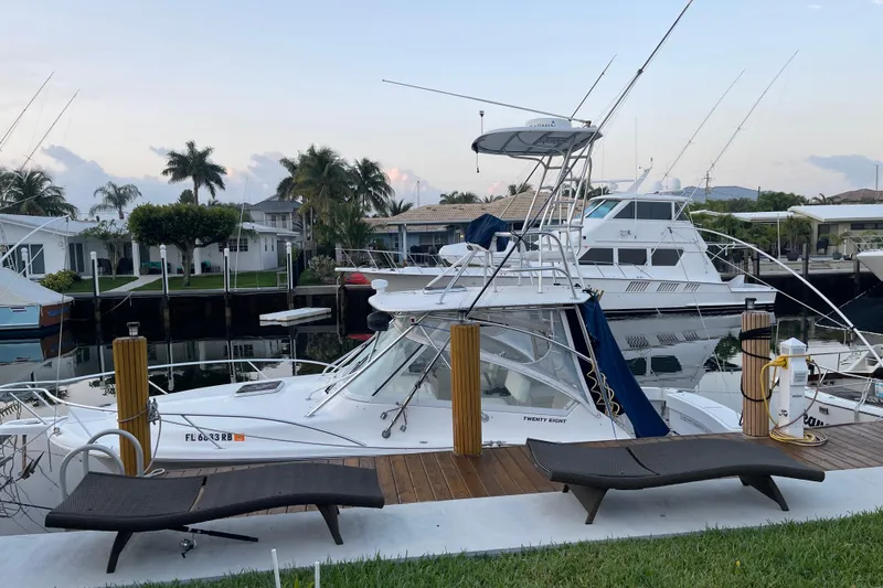 Slide: The Image of 2007 Luhrs 28 Open boat docked at marina with palm trees in background. - 92