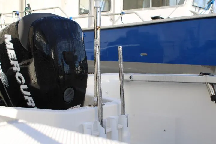 Slide: The Image of 2010 Trophy 1802 Walkaround boat with Mercury outboard motor in marina setting. - 14