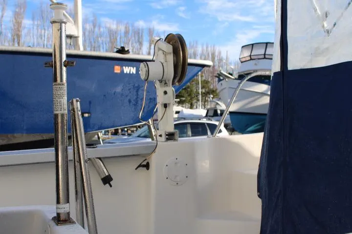 Slide: The Image of 2010 Trophy 1802 Walkaround boat interior with fishing equipment and blue cover. - 16