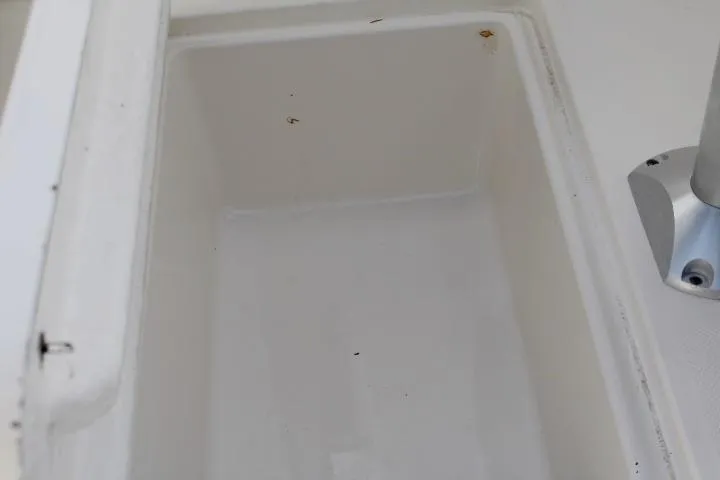 Slide: The Image of 2010 Trophy 1802 Walkaround boat storage compartment, white interior, close-up view. - 22