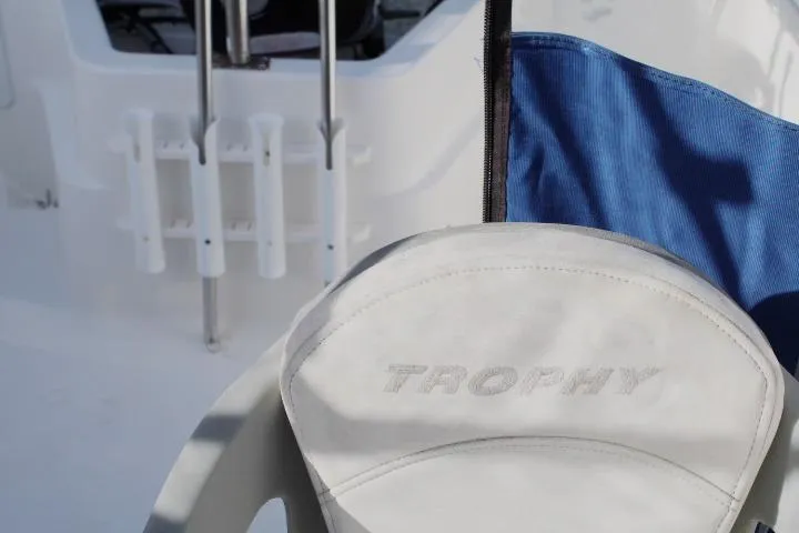 Slide: The Image of 2010 Trophy 1802 Walkaround boat seat with logo, featuring blue and white upholstery. - 23