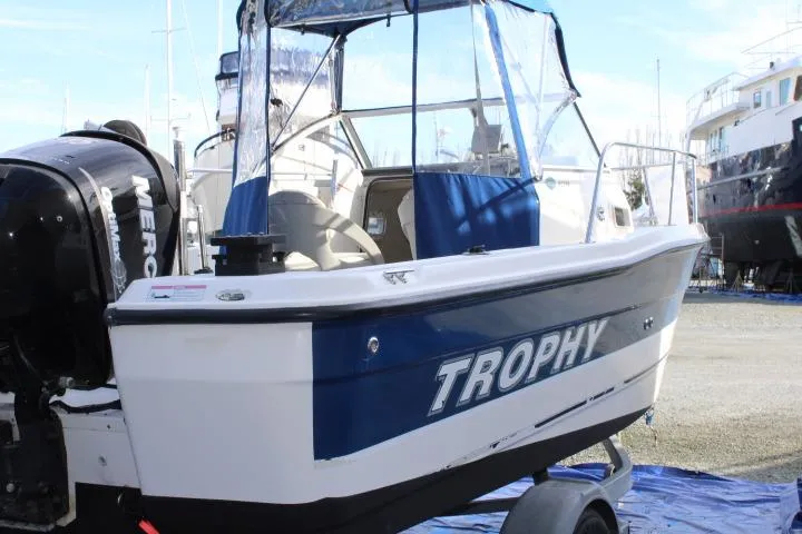 Slide: The Image of 2010 Trophy 1802 Walkaround boat on trailer, featuring a Mercury outboard motor. - 4