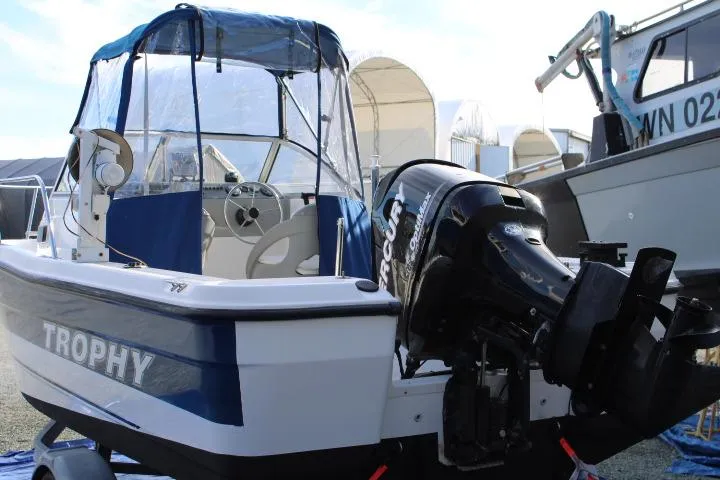 Slide: The Image of 2010 Trophy 1802 Walkaround boat with Mercury outboard motor, docked in a marina. - 5