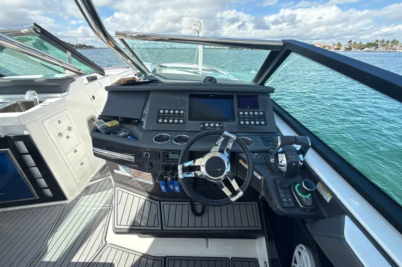 Slide: The Image of Cockpit of 2019 Monterey 385 Super Express boat with modern controls and steering wheel. - 14