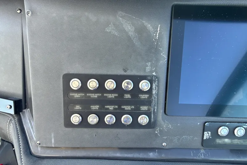 Slide: The Image of Control panel of a 2019 Monterey 385 Super Express boat with labeled switches. - 16