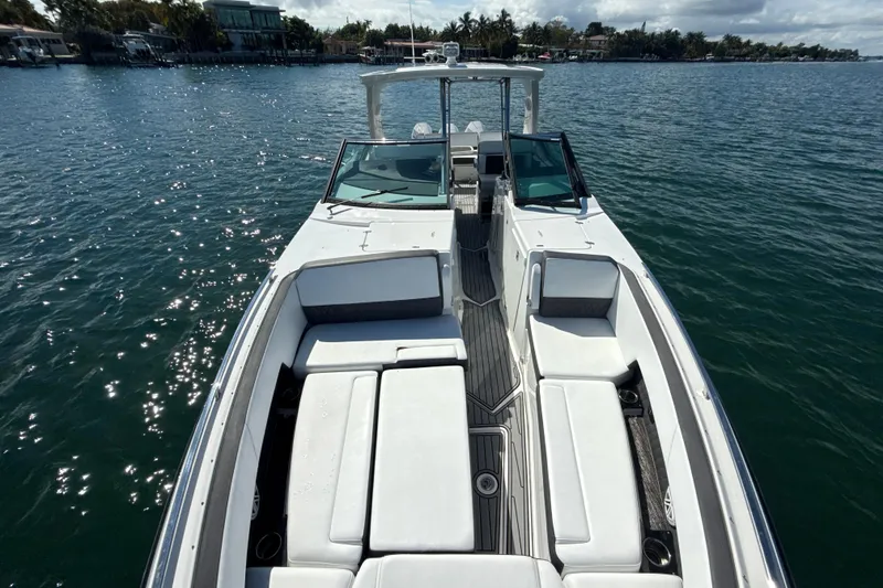 Slide: The Image of 2019 Monterey 385 Super Express boat on calm water, featuring spacious seating. - 21