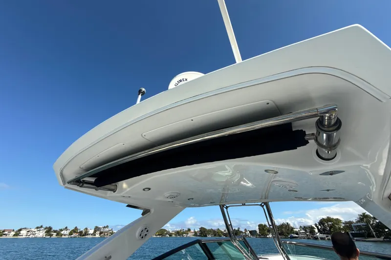 Slide: The Image of 2019 Monterey 385 Super Express boat on water, showcasing sleek design and clear blue sky. - 23