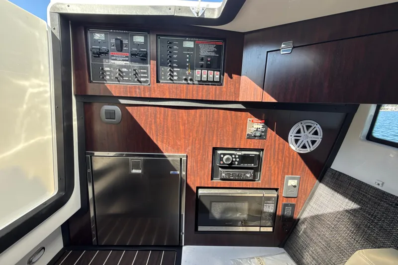 Slide: The Image of Control panel and appliances inside a 2019 Monterey 385 Super Express boat cabin. - 25