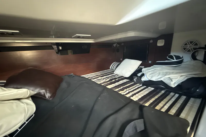 Slide: The Image of Interior cabin of 2019 Monterey 385 Super Express with striped bedding and pillows. - 27