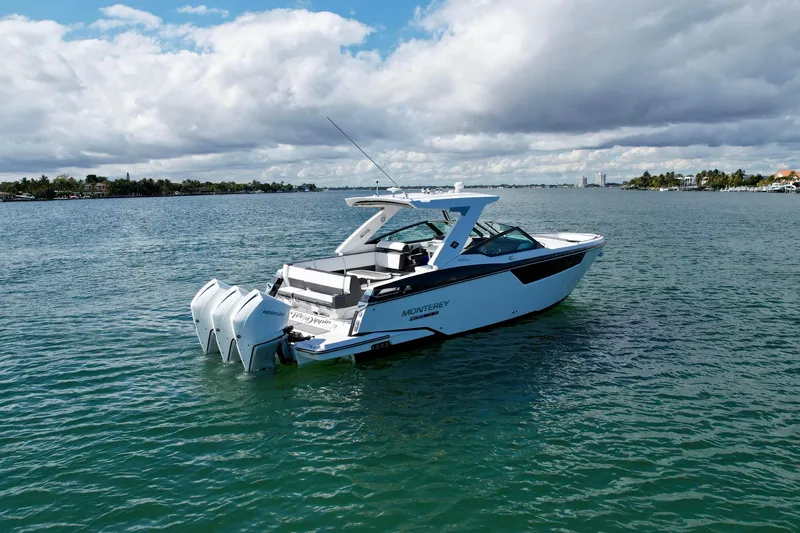 Slide: The Image of 2019 Monterey 385 Super Express boat on calm water under cloudy sky. - 3