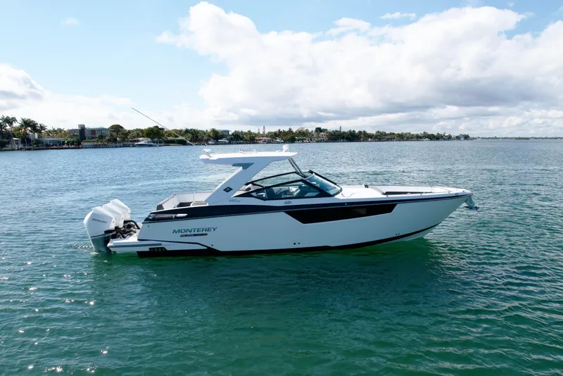Slide: The Image of 2019 Monterey 385 Super Express boat on calm water under a partly cloudy sky. - 4