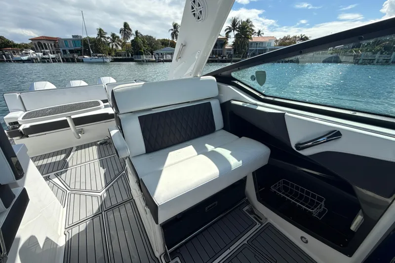 Slide: The Image of 2019 Monterey 385 Super Express boat interior with luxurious seating and waterfront view. - 11