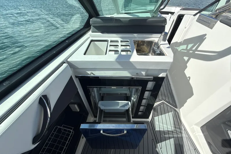 Slide: The Image of 2019 Monterey 385 Super Express boat interior with kitchenette and sink. - 13