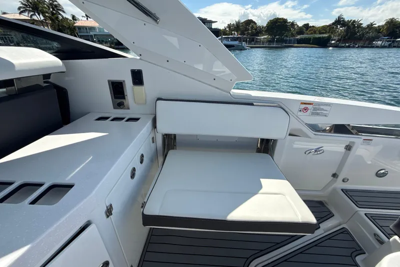 Slide: The Image of 2019 Monterey 385 Super Express boat interior with white seating and sleek design. - 22