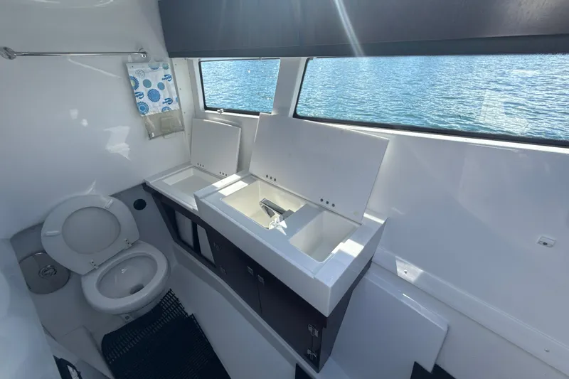 Slide: The Image of Bathroom interior of 2019 Monterey 385 Super Express yacht with dual sinks and toilet. - 28