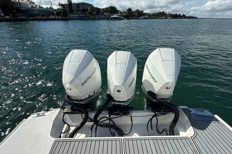 Slide: The Image of 2019 Monterey 385 Super Express with triple Mercury outboard engines on a sunny day. - 5