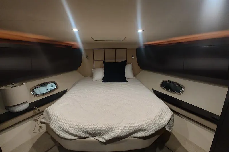 Slide: The Image of Luxurious cabin interior of 2016 Regal 53 Sport Coupe yacht with cozy bed and ambient lighting. - 17