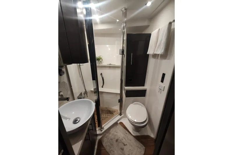 Slide: The Image of Luxurious bathroom in 2016 Regal 53 Sport Coupe yacht with modern fixtures and elegant design. - 19