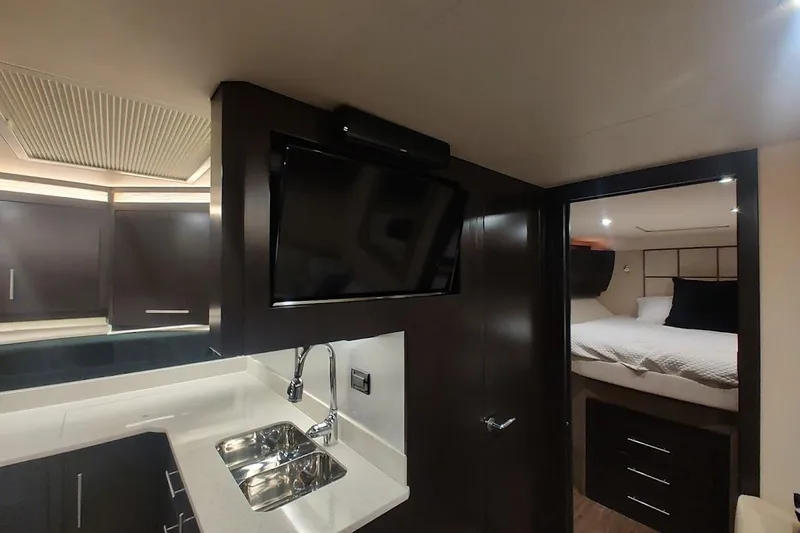 Slide: The Image of Interior of 2016 Regal 53 Sport Coupe yacht with modern kitchen and cozy bedroom. - 20