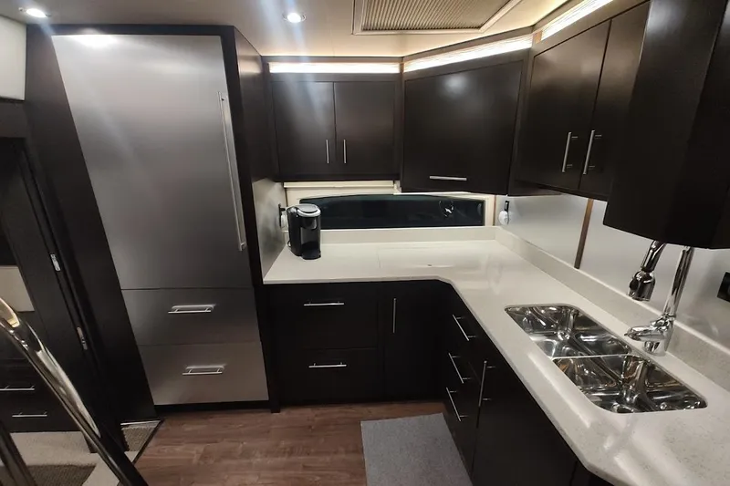 Slide: The Image of Luxurious kitchen interior of 2016 Regal 53 Sport Coupe yacht with modern cabinetry and appliances. - 21