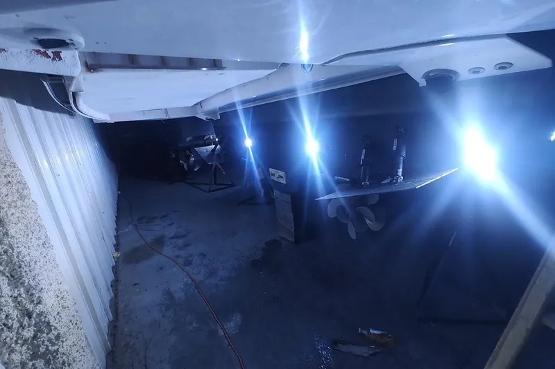 Slide: The Image of 2016 Regal 53 Sport Coupe underbody with bright lights in a dimly lit area. - 32